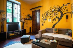a living room with a couch and a tv at Five Trees in Sliema