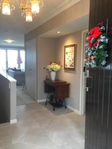 a hallway with a vase of flowers on a table at KARANDA BnB in Rotorua