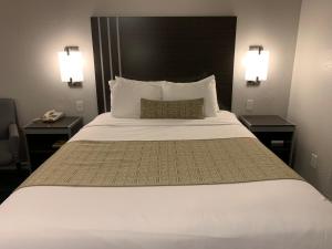 a large bed in a hotel room with two night stands at Sand Castle Inn in Seaside