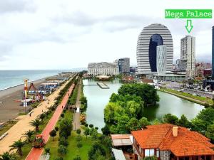 a view of a city with a river and a beach at Panorama Sea View Studio! in Batumi