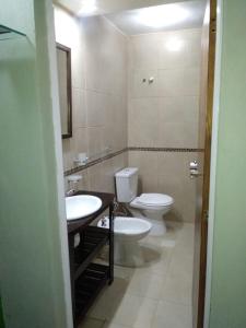 a bathroom with a toilet and a sink at Balcones de Molinari in Cosquín