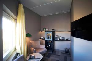 a living room with a chair and a window at Hotel Lautrup Park in Ballerup