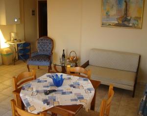 a living room with a table and chairs and a couch at Panos Village in Maláxa