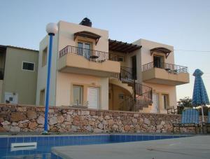 a house with two balconies and a swimming pool at Panos Village in Maláxa