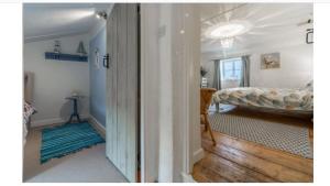 a bedroom with a bed and a room with a hallway at Lovely Cottage in North Creake