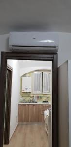 a kitchen with a sink and a ceiling at Sedile Del Campo House in Salerno