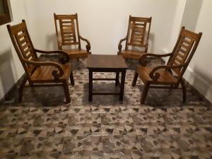 a group of four chairs and a table in a room at Lake View Villa in Mirissa