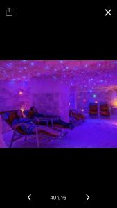a room with purple lights on the ceilings at Chalets in Porto Sokhna - Pyramids - Families Only in Ain Sokhna