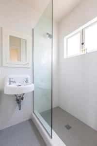 a bathroom with a sink and a glass shower at Sonder The Bungalows in San Diego