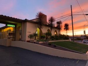 a building with a sign on the side of it at El Castell Motel in Monterey