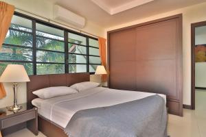 Postel nebo postele na pokoji v ubytování Sweet Villas Pattaya