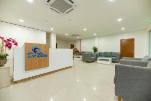a waiting room with couches and a sign on a wall at Langkawi De Bleu Hotel in Kuah