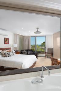 a bedroom with a bed and a large mirror at Luna Blu - Luxury B&B in Rhyll