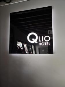 a sign for a clio hotel on a wall at Qlio Hotel in Kota Kinabalu