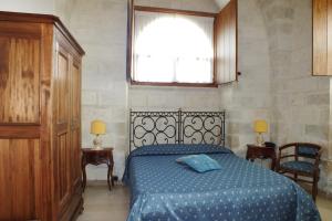 Кровать или кровати в номере Masseria Gattamora