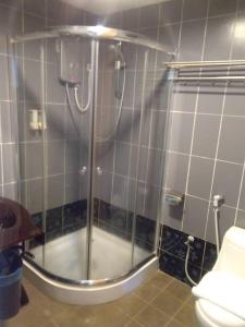 a shower with a glass door in a bathroom at Hotel Mewah Impiana in Kota Bharu