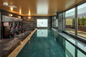 an indoor pool with a basketball hoop in a building at Wat Hotel & Spa Hida Takayama in Takayama
