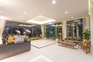 a lobby of a building with people sitting at a counter at Donchan Grand Hotel in Chiang Mai