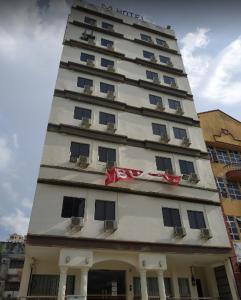 a tall white building with windows on top of it at Hotel Mewah Impiana in Kota Bharu