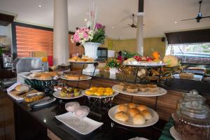 a buffet with many plates of food on a table at Sita Beach Resort in Ko Lipe