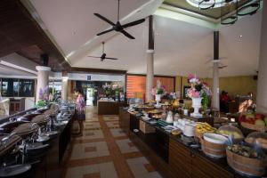 a buffet line in a restaurant with a woman standing in the background at Sita Beach Resort in Ko Lipe