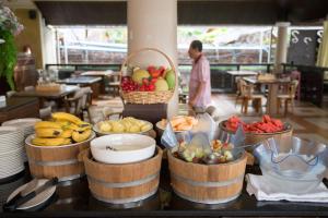 a buffet with bowls of fruit on a table at Sita Beach Resort in Ko Lipe