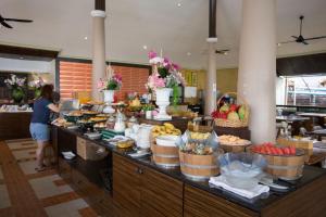 a woman standing at a buffet in a hotel at Sita Beach Resort in Ko Lipe