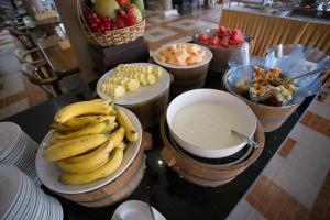 a bunch of bananas on a counter with bowls of fruit at Sita Beach Resort in Ko Lipe