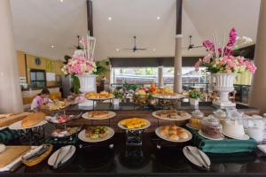 a buffet with many plates of food on a table at Sita Beach Resort in Ko Lipe