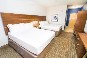 a bedroom with a bed and a desk at Holiday Inn Express & Suites Las Vegas SW Springvalley, an IHG Hotel in Las Vegas