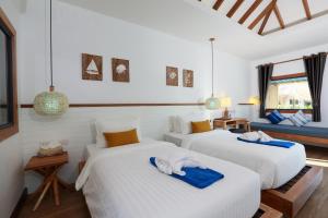 two beds in a room with white walls at Lanta Casa Blanca in Ko Lanta +83 photos