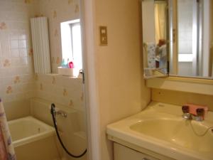 a bathroom with a tub and a sink and a bath tub at Special Honmachi in Okayama