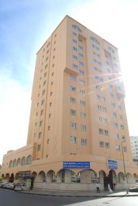 a large building on the corner of a street at Basma Residence Hotel Apartments in Sharjah