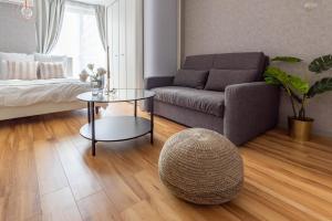 a living room with a couch and a table at Exia Daikoku AFP Apartment in Osaka