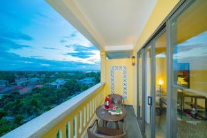 a balcony with a table and chairs and a view at Hoi An Central Boutique Hotel & Spa (Little Hoi An Central Boutique Hotel & Spa) in Hoi An +199 photos