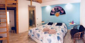 a bedroom with a bed with two towels on it at La Perla del Sud in Teulada