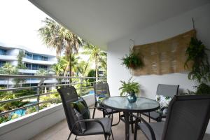 a patio with a table and chairs on a balcony at Hua Hin Beachfront Condo in Hua Hin