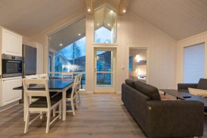 eine Küche und ein Esszimmer mit einem Tisch und Stühlen in der Unterkunft Jølstraholmen Camping og Hytter in Vassenden