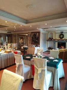 a dining room with white tables and white chairs at Hotel Vandelli in Pavullo nel Frignano