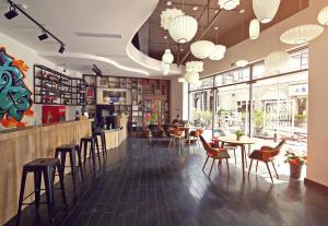 a restaurant with a bar with chairs and tables at Shanghai Chi Chen Boutique Hotel in Shanghai