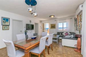 - une salle à manger et un salon avec une table et des chaises dans l'établissement Apartments Babaja, à Trogir
