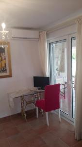 a room with a desk with a computer and a red chair at NN room near the Athens airport in Spata