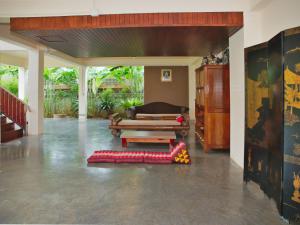 uma sala de estar com um sofá e uma mesa em Chanapha Residence em Praia de Tab Kaek