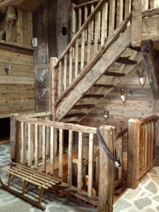 a wooden staircase in a room with a bench at Chalet 1692 in Bonneval-sur-Arc