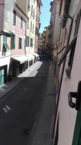 an empty street in a city with buildings at Maison Verika in Chiavari