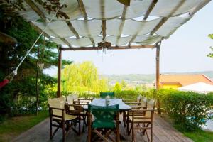 a patio with a table and chairs under a pergola at Bozis Private Pool Villa, Siviri in Siviri