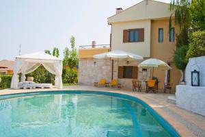 a swimming pool in front of a house at Bozis Private Pool Villa, Siviri in Siviri