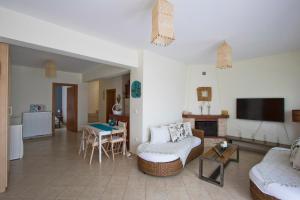 a living room with a couch and a table at Bozis Private Pool Villa, Siviri in Siviri