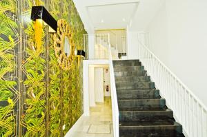 a staircase in a building with a mural on the wall at NineSuites in Seville
