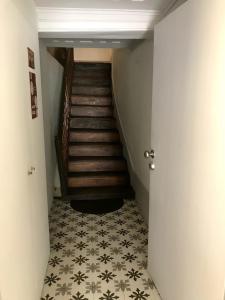 a hallway with a staircase and a floor with a tile floor at Casa Santa Luzia - Historic Centre in Guimarães